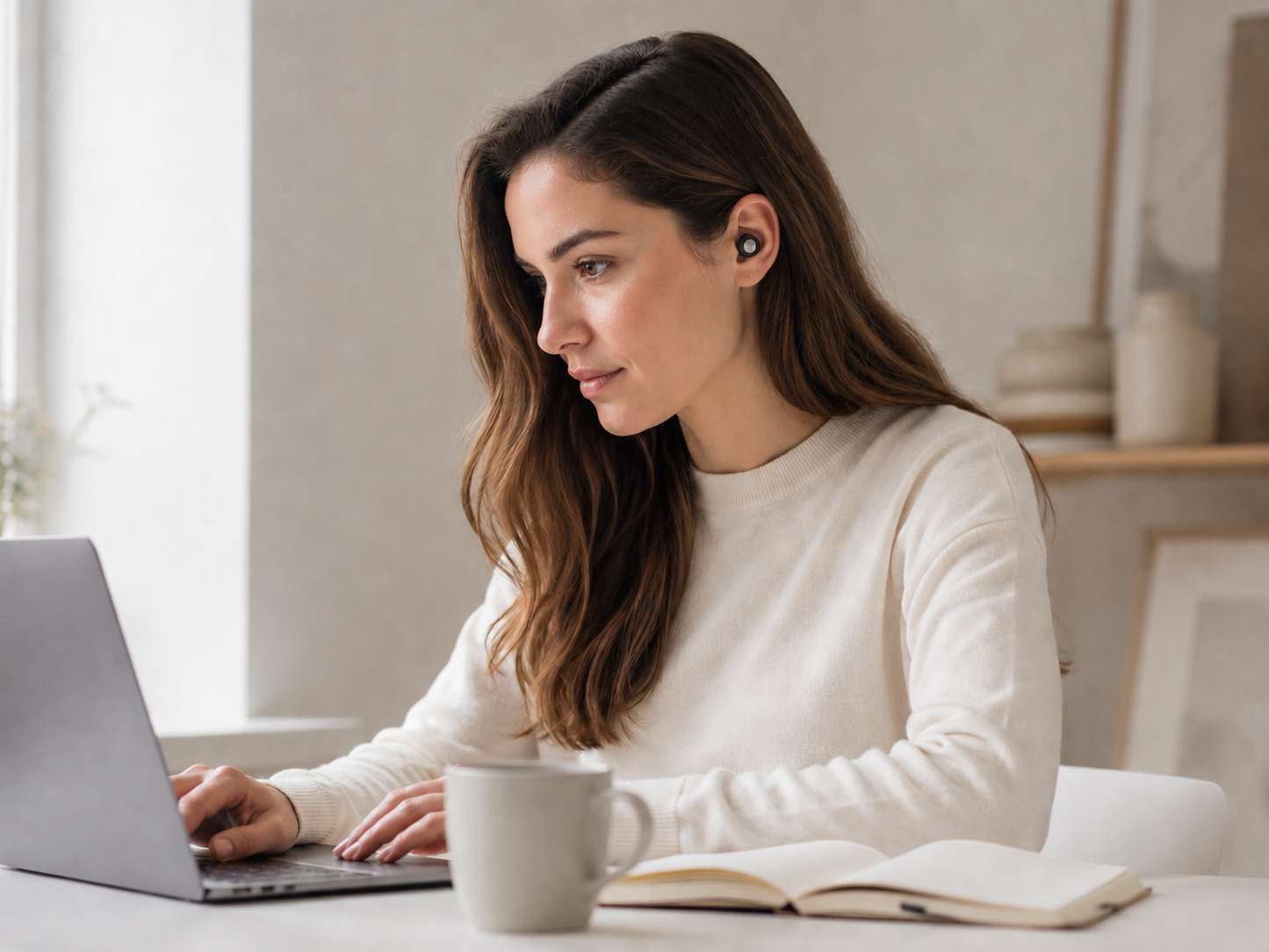 Close-up of a matte black AURALIS silicone earplug, low-profile and discreet
